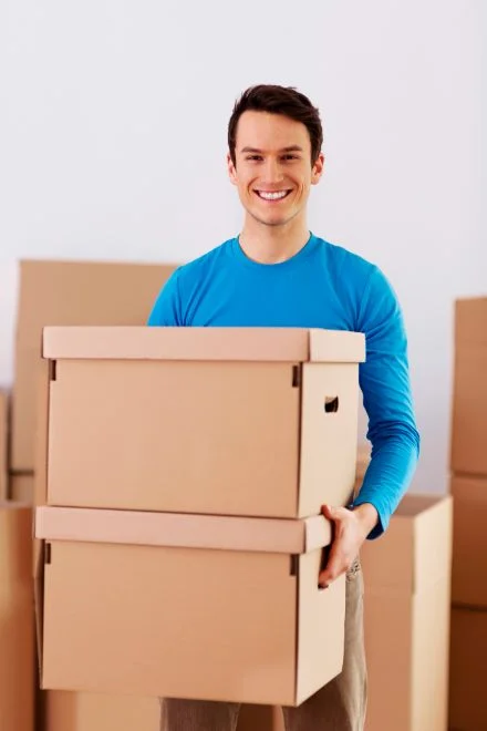 Packers and Movers in Renukoot Holding Boxes